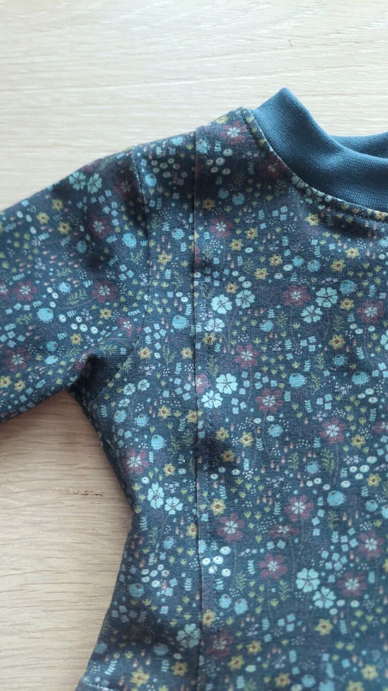 A close-up of the shirt showing the front, side and sleeve seams.